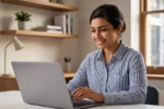 A professional photograph of a young Indian tech professional working on a laptop, depicting a freelancer overcoming a career gap in IT.